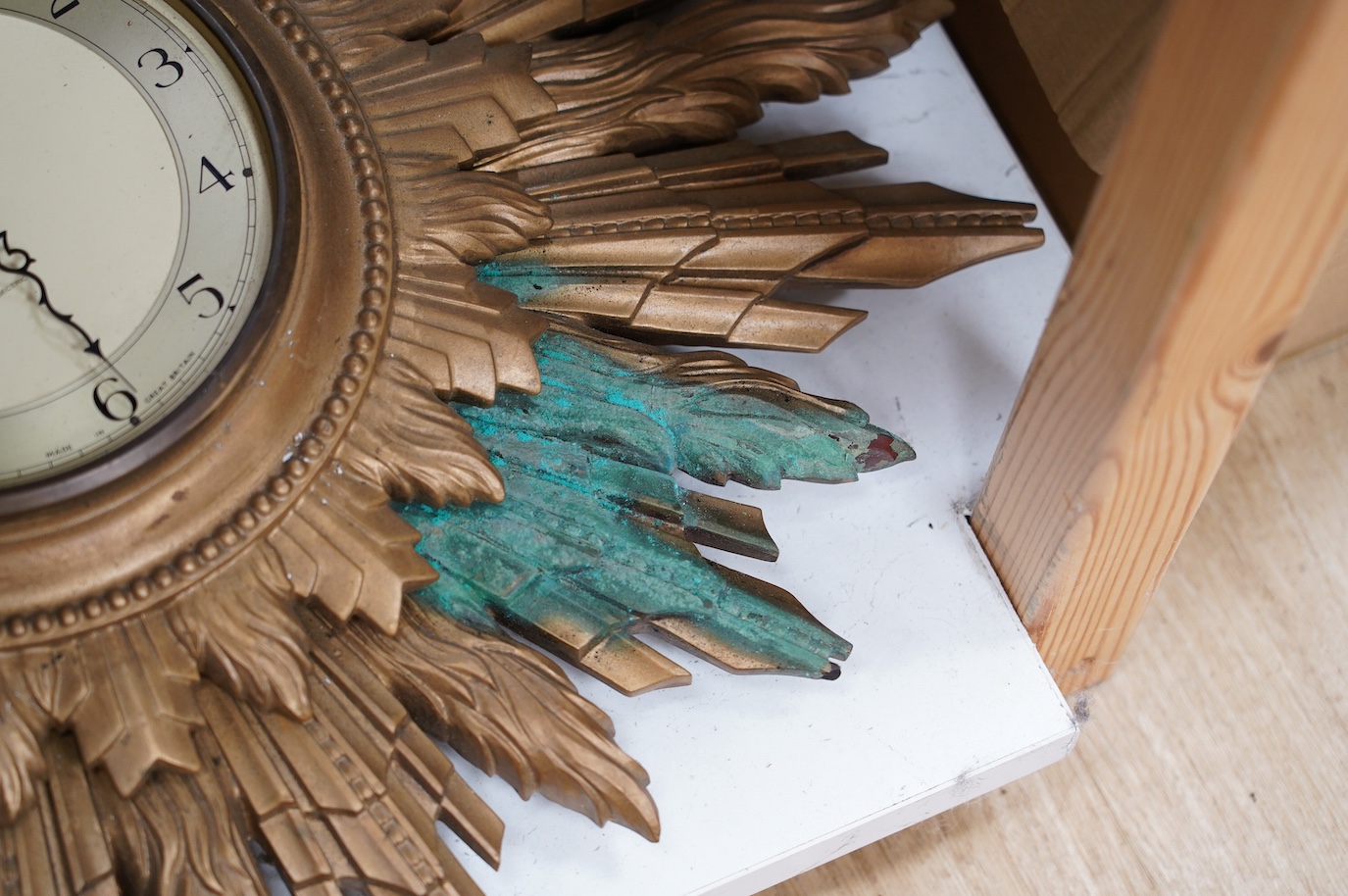 A Smiths gilt sunburst framed wall dial clock and two similar sunburst frames, Smiths clock and frame 69cm wide. Condition - poor to fair